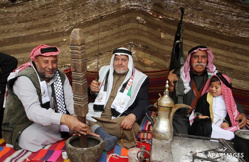Palestinian men gather in a tent to mark Land Day on March 30, 2016, in Khan Yunis, in the southern Gaza Strip, as Palestinians mark Land Day. March 30 marks Land Day, the annual commemorations of the killing by police o...