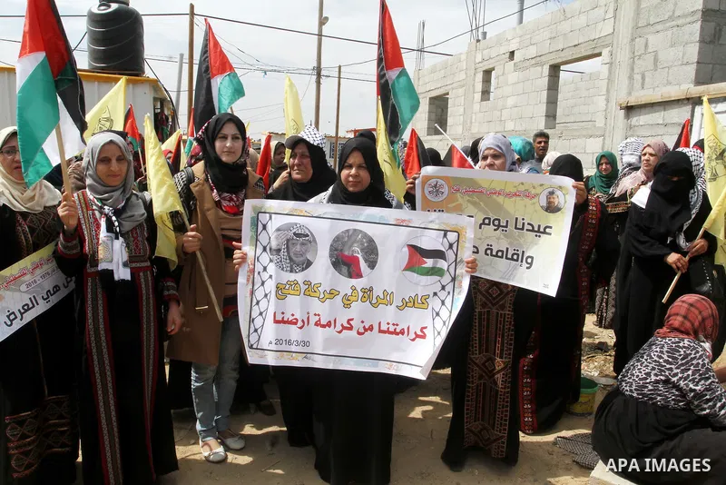 Palestinian women take part in a protest to mark Land Day on March 30, 2016, in Khan Yunis, in the southern Gaza Strip. March 30 marks Land Day, the annual commemorations of the killing by police of six Arab citizens in...
