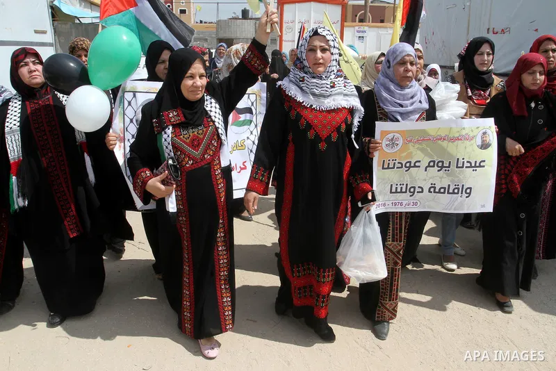 Palestinian women take part in a protest to mark Land Day on March 30, 2016, in Khan Yunis, in the southern Gaza Strip. March 30 marks Land Day, the annual commemorations of the killing by police of six Arab citizens in...