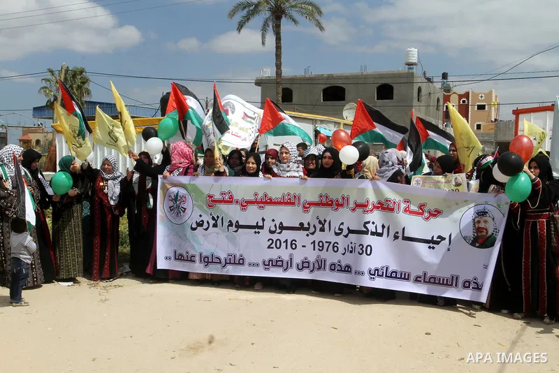 Palestinian women take part in a protest to mark Land Day on March 30, 2016, in Khan Yunis, in the southern Gaza Strip. March 30 marks Land Day, the annual commemorations of the killing by police of six Arab citizens in...