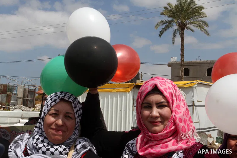 Palestinian women take part in a protest to mark Land Day on March 30, 2016, in Khan Yunis, in the southern Gaza Strip. March 30 marks Land Day, the annual commemorations of the killing by police of six Arab citizens in...