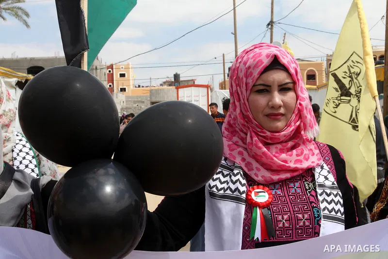 Palestinian women take part in a protest to mark Land Day on March 30, 2016, in Khan Yunis, in the southern Gaza Strip. March 30 marks Land Day, the annual commemorations of the killing by police of six Arab citizens in...