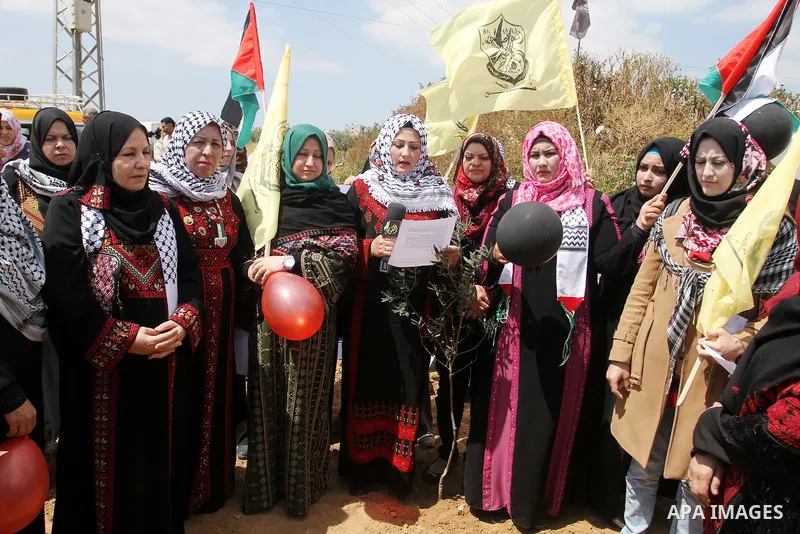 Palestinian women take part in a protest to mark Land Day on March 30, 2016, in Khan Yunis, in the southern Gaza Strip. March 30 marks Land Day, the annual commemorations of the killing by police of six Arab citizens in...