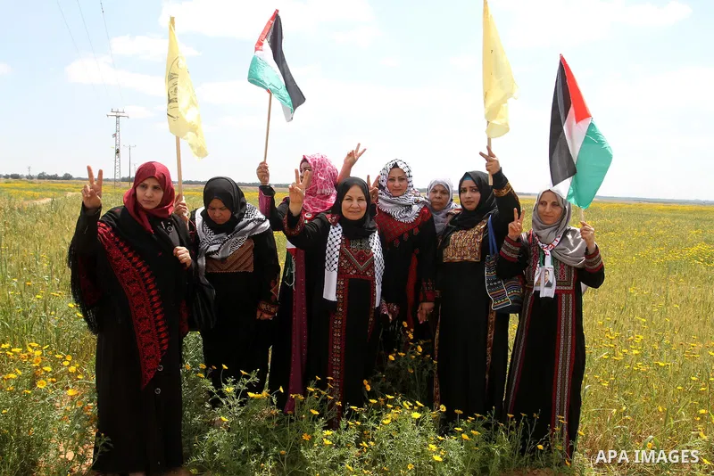 Palestinian women take part in a protest to mark Land Day on March 30, 2016, in Khan Yunis, in the southern Gaza Strip. March 30 marks Land Day, the annual commemorations of the killing by police of six Arab citizens in...