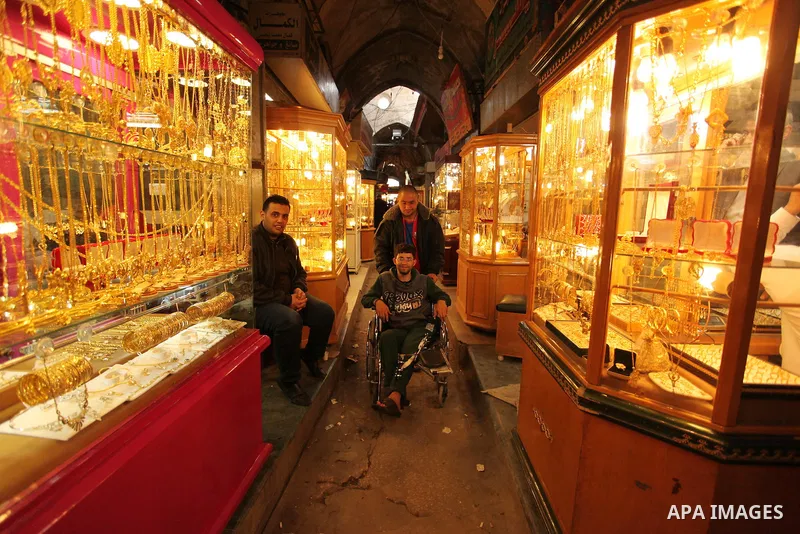 Palestinians walk past jewellery stores in Gaza city on March 30, 2016. The director of the Palestinian Authority’s borders and crossings department, Nathmi Muhanna said that Israeli authorities notified his department t...