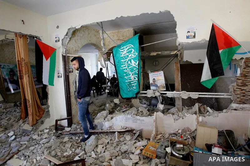 Palestinians check the damage house of Ihab Maswada that was demolished by the Israeli army in the West Bank city of Hebron March 31, 2016. Ihab Maswada was killed on Dec. 7 after carrying out a stabbing attack against a...