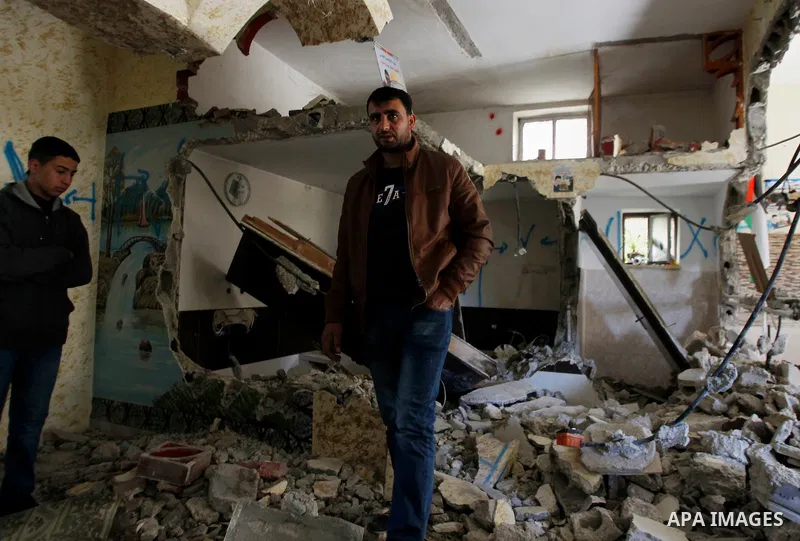 Palestinians check the damage house of Ihab Maswada that was demolished by the Israeli army in the West Bank city of Hebron March 31, 2016. Ihab Maswada was killed on Dec. 7 after carrying out a stabbing attack against a...