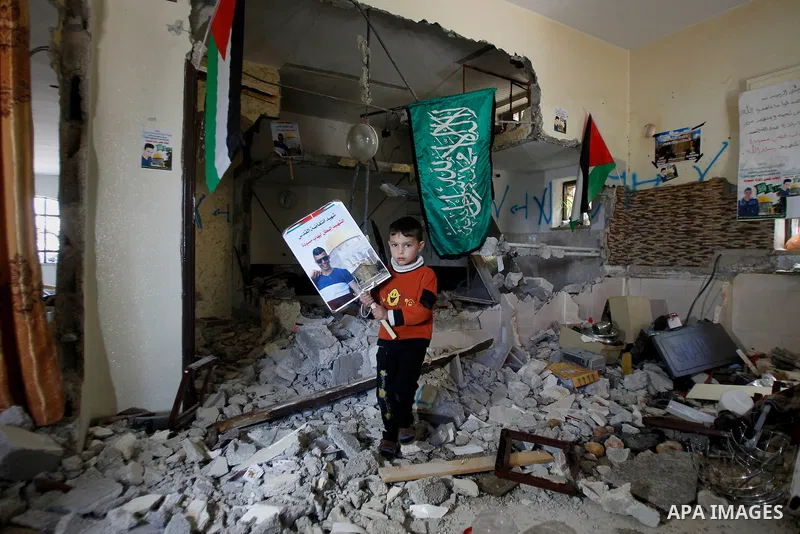 Palestinians check the damage house of Ihab Maswada that was demolished by the Israeli army in the West Bank city of Hebron March 31, 2016. Ihab Maswada was killed on Dec. 7 after carrying out a stabbing attack against a...