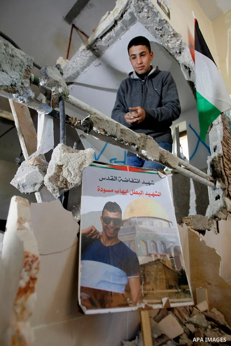 Palestinians check the damage house of Ihab Maswada that was demolished by the Israeli army in the West Bank city of Hebron March 31, 2016. Ihab Maswada was killed on Dec. 7 after carrying out a stabbing attack against a...