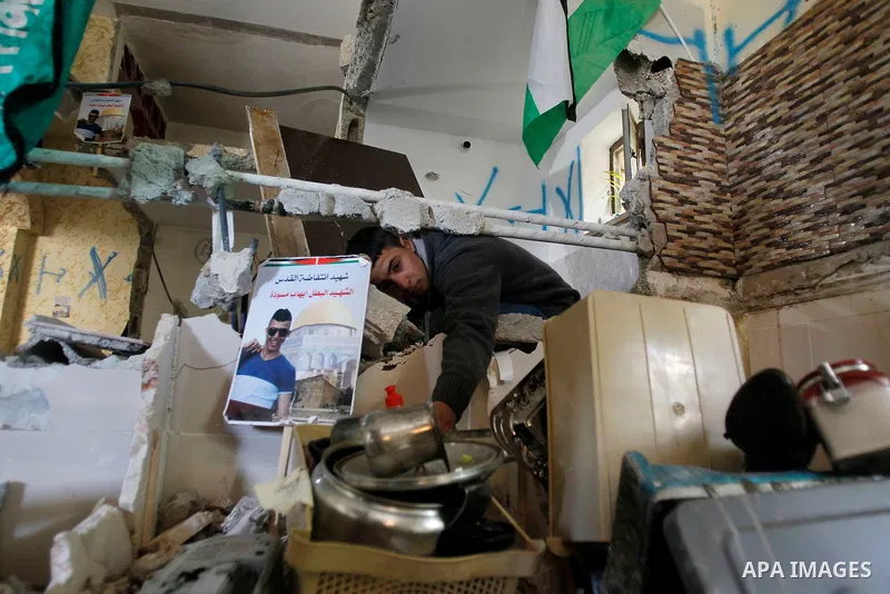 Palestinians check the damage house of Ihab Maswada that was demolished by the Israeli army in the West Bank city of Hebron March 31, 2016. Ihab Maswada was killed on Dec. 7 after carrying out a stabbing attack against a...
