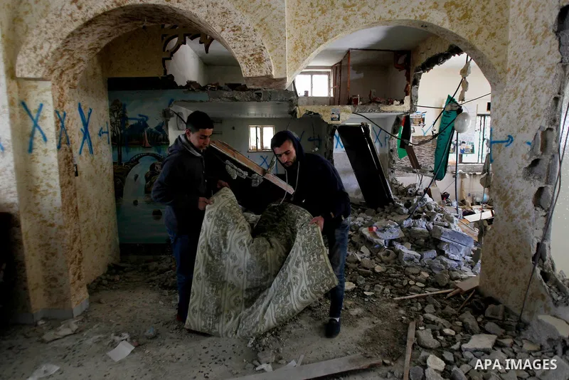 Palestinians check the damage house of Ihab Maswada that was demolished by the Israeli army in the West Bank city of Hebron March 31, 2016. Ihab Maswada was killed on Dec. 7 after carrying out a stabbing attack against a...