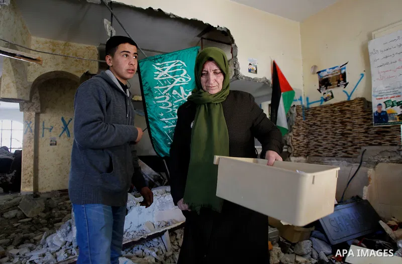 Palestinians check the damage house of Ihab Maswada that was demolished by the Israeli army in the West Bank city of Hebron March 31, 2016. Ihab Maswada was killed on Dec. 7 after carrying out a stabbing attack against a...