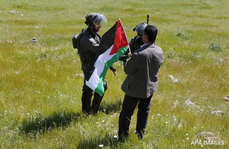 A Palestinian protester argues with Israeli border guards during clashes following a march against Palestinian land confiscation on April 1, 2016 in the West Bank village of Nabi Saleh near Ramallah. Photo by Hamza Shala...
