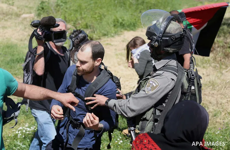 A Palestinian protester scuffles with Israeli border guards during clashes following a march against Palestinian land confiscation on April 1, 2016 in the West Bank village of Nabi Saleh near Ramallah. Photo by Hamza Sha...
