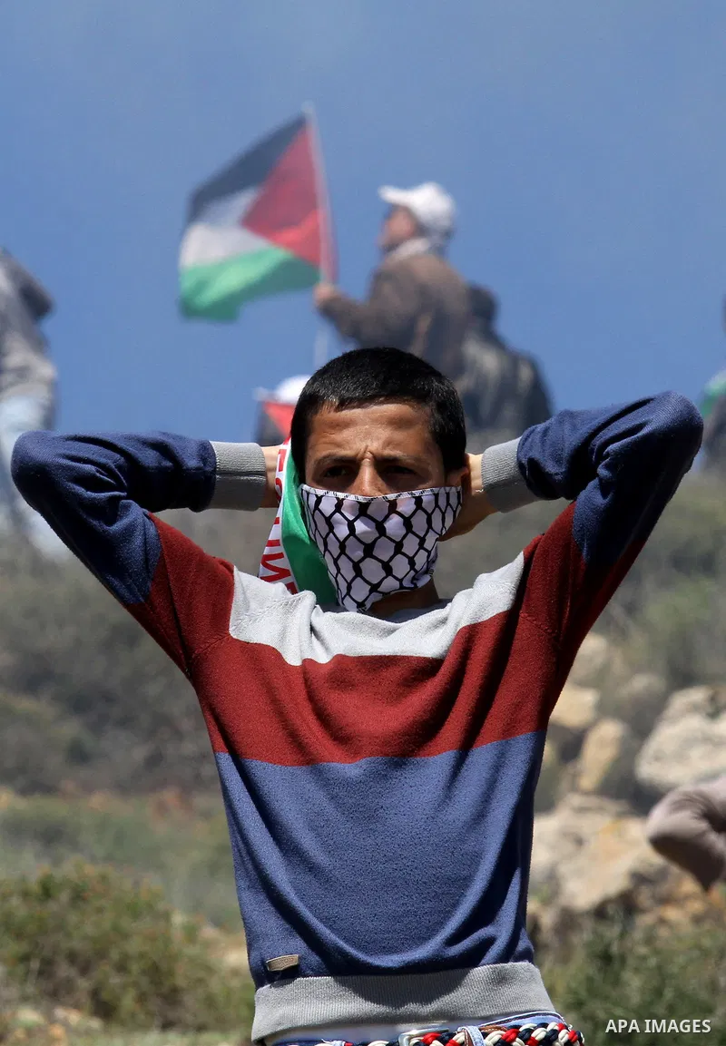 A Palestinian protester takes part during clashes with Israeli security forces following a demonstration against Jewish settlements in the West Bank village of Qaryout near Nablus on April 01, 2016. Photo by Nedal Eshtay...