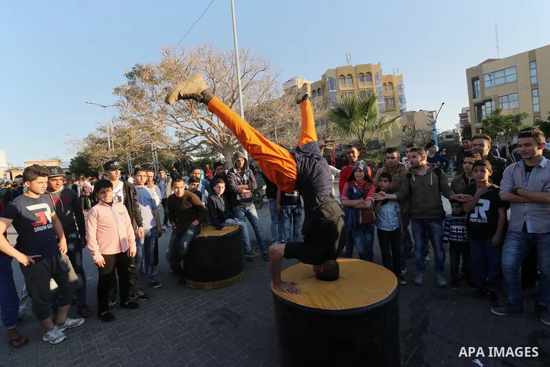 A Palestinian performs stunts during a cultural carnival organized by Gaza Municipality in Gaza City April 1, 2016. Photo by Mohammed Asad