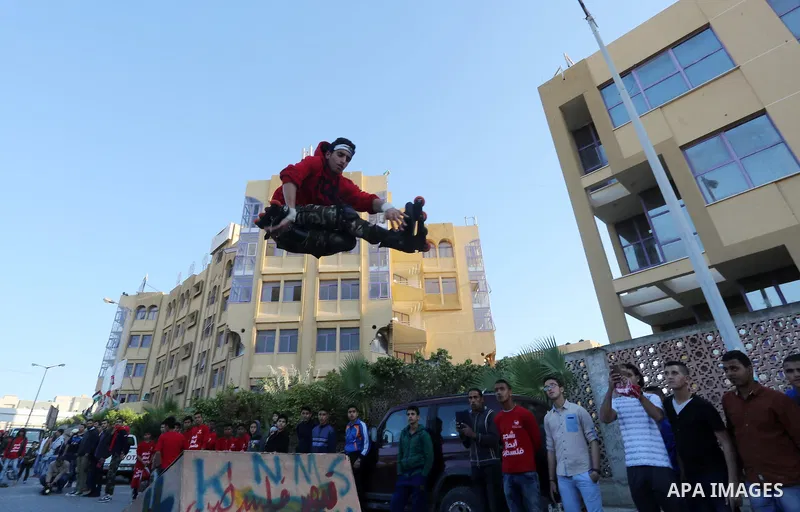 A Palestinian performs stunts during a cultural carnival organized by Gaza Municipality in Gaza City April 1, 2016. Photo by Mohammed Asad