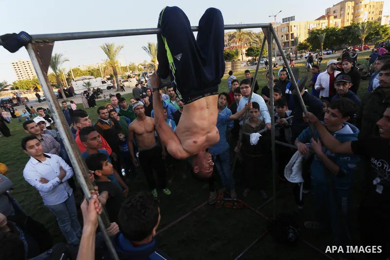 A Palestinian performs stunts during a cultural carnival organized by Gaza Municipality in Gaza City April 1, 2016. Photo by Mohammed Asad