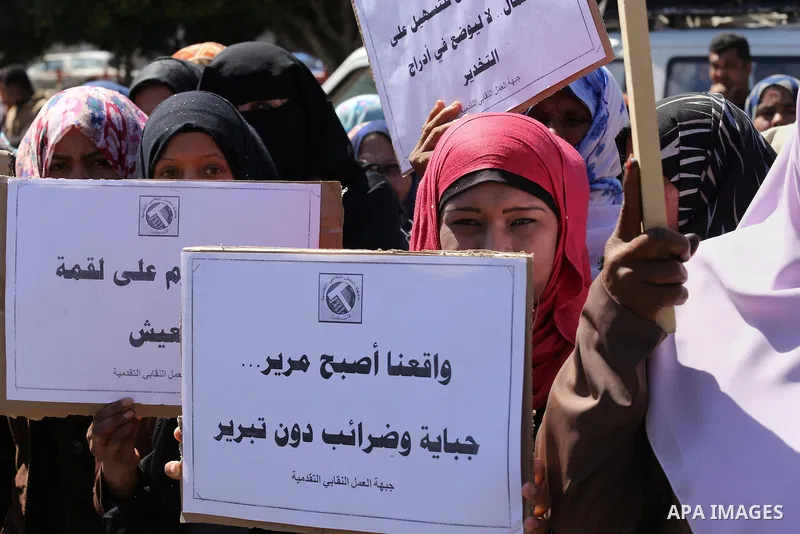 Palestinian supporters of Popular front for Liberation of Palestine (PFLP) hold banners during a protest against the siege of Gaza, in Gaza City, on April 2, 2016. Photo by Mohammed Asad