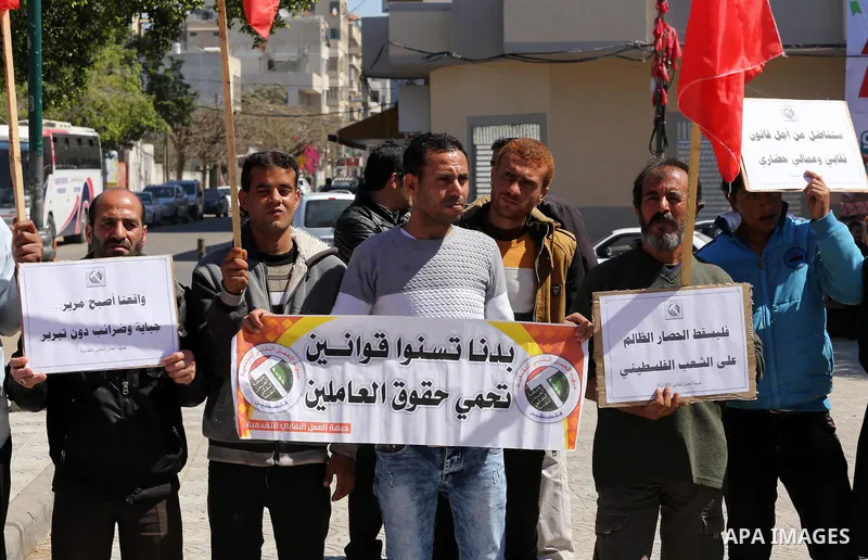 Palestinian supporters of Popular front for Liberation of Palestine (PFLP) hold banners during a protest against the siege of Gaza, in Gaza City, on April 2, 2016. Photo by Mohammed Asad