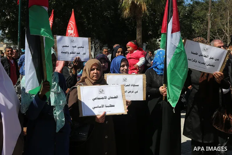 Palestinian supporters of Popular front for Liberation of Palestine (PFLP) hold banners during a protest against the siege of Gaza, in Gaza City, on April 2, 2016. Photo by Mohammed Asad