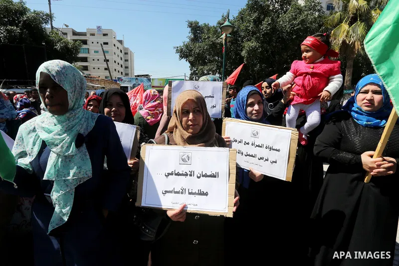 Palestinian supporters of Popular front for Liberation of Palestine (PFLP) hold banners during a protest against the siege of Gaza, in Gaza City, on April 2, 2016. Photo by Mohammed Asad