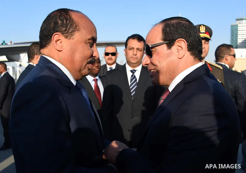 A handout picture released by the Egyptian Presidency on April 2, 2016 shows Egyptian President Abdel Fattah al-Sisi welcoming Mauritania President Mohamed Ould Abdel Aziz upon his arrival at Cairo International Airport....