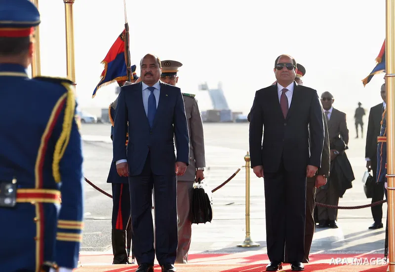A handout picture released by the Egyptian Presidency on April 2, 2016 shows Egyptian President Abdel Fattah al-Sisi welcoming Mauritania President Mohamed Ould Abdel Aziz upon his arrival at Cairo International Airport....