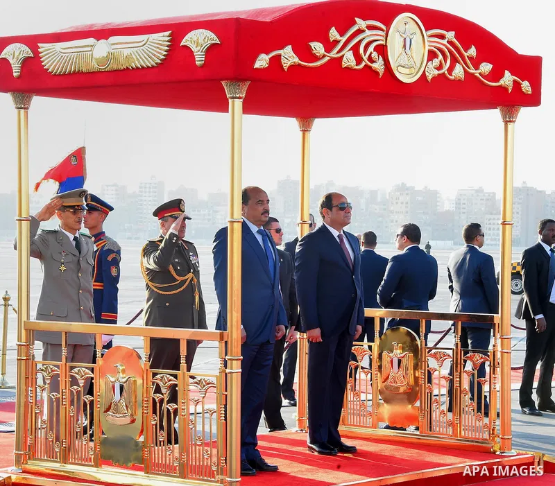 A handout picture released by the Egyptian Presidency on April 2, 2016 shows Egyptian President Abdel Fattah al-Sisi welcoming Mauritania President Mohamed Ould Abdel Aziz upon his arrival at Cairo International Airport....