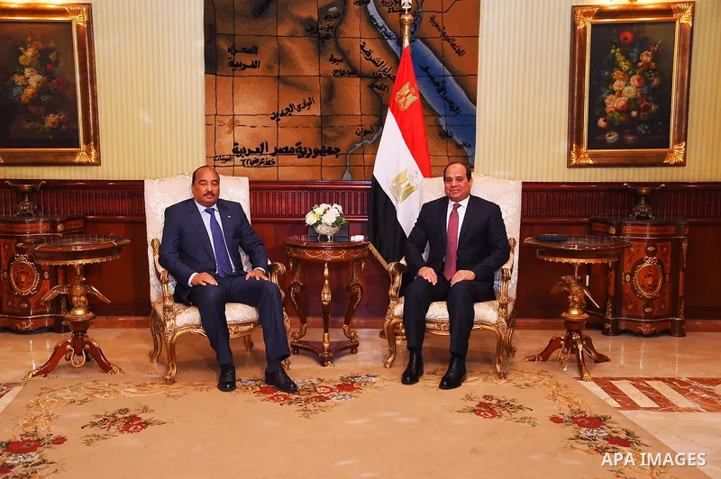 A handout picture released by the Egyptian Presidency on April 2, 2016 shows Egyptian President Abdel Fattah al-Sisi welcoming Mauritania President Mohamed Ould Abdel Aziz upon his arrival at Cairo International Airport....
