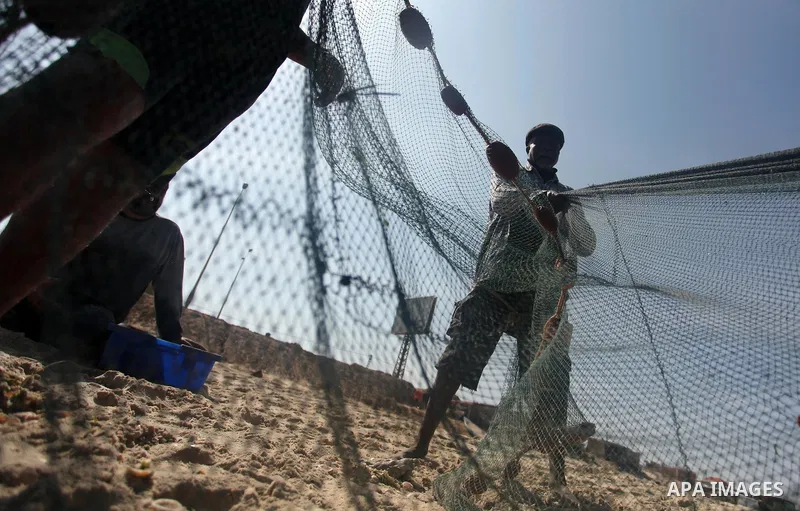 Palestinian fishermen throw thier nets into the sea at the beach of Gaza City on April 03, 2016. Israel on Sunday extended the distance it permits Gaza fishermen to head out to sea along certain parts of the coastline of...