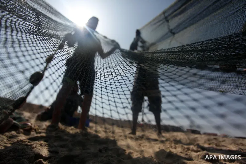 Palestinian fishermen pull their net at the beach in Gaza City on April 03, 2016. Israel on Sunday extended the distance it permits Gaza fishermen to head out to sea along certain parts of the coastline of the enclave, w...