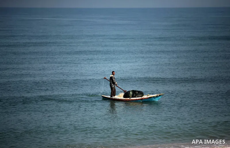 A Palestinian fisherman rides his fishing boat at the beach of Gaza City on April 03, 2016. Israel on Sunday extended the distance it permits Gaza fishermen to head out to sea along certain parts of the coastline of the...