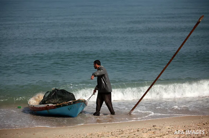 A Palestinian fisherman rides his fishing boat at the beach of Gaza City on April 03, 2016. Israel on Sunday extended the distance it permits Gaza fishermen to head out to sea along certain parts of the coastline of the...