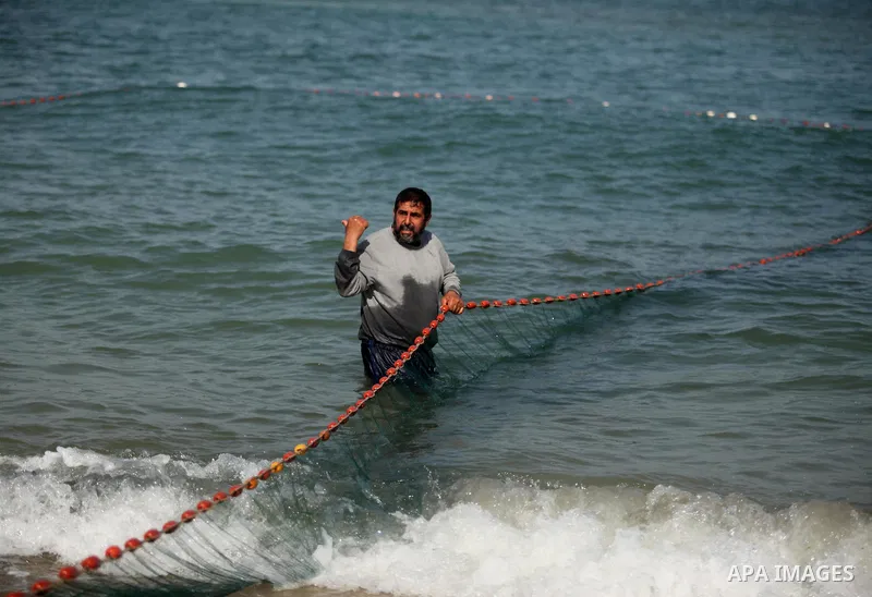 Palestinian fishermen throw thier nets into the sea at the beach of Gaza City on April 03, 2016. Israel on Sunday extended the distance it permits Gaza fishermen to head out to sea along certain parts of the coastline of...