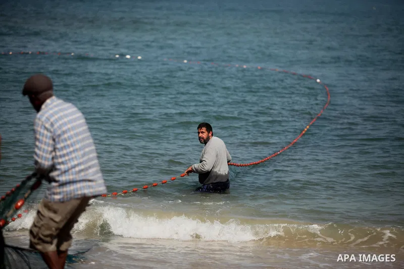 Palestinian fishermen throw thier nets into the sea at the beach of Gaza City on April 03, 2016. Israel on Sunday extended the distance it permits Gaza fishermen to head out to sea along certain parts of the coastline of...