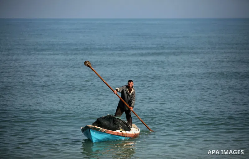 A Palestinian fisherman rides his fishing boat at the beach of Gaza City on April 03, 2016. Israel on Sunday extended the distance it permits Gaza fishermen to head out to sea along certain parts of the coastline of the...