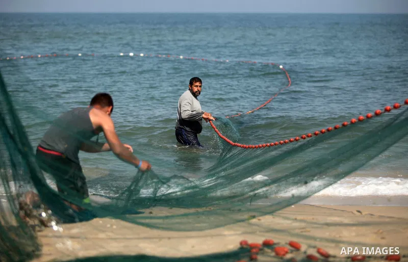 Palestinian fishermen throw thier nets into the sea at the beach of Gaza City on April 03, 2016. Israel on Sunday extended the distance it permits Gaza fishermen to head out to sea along certain parts of the coastline of...