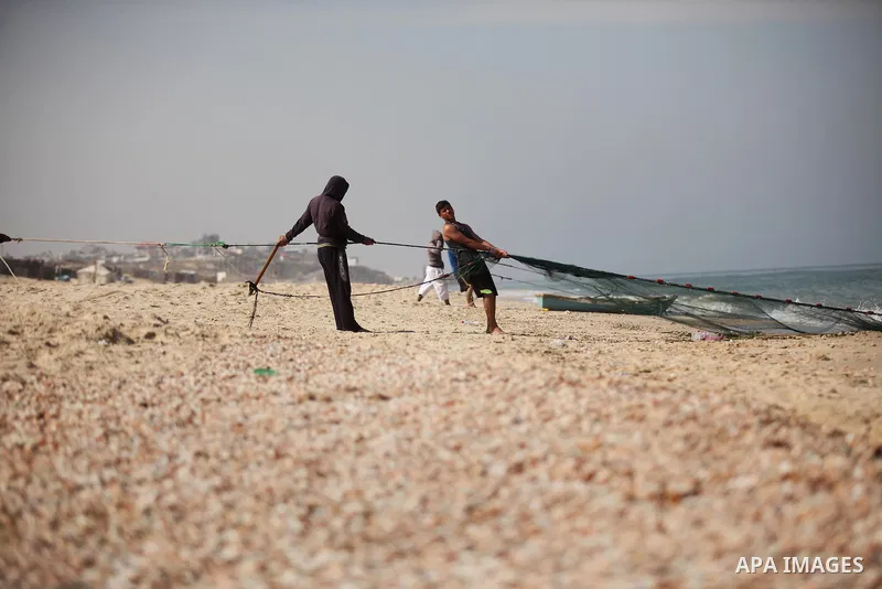 Palestinian fishermen throw thier nets into the sea at the beach of Gaza City on April 03, 2016. Israel on Sunday extended the distance it permits Gaza fishermen to head out to sea along certain parts of the coastline of...