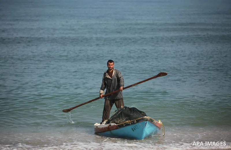 A Palestinian fisherman rides his fishing boat at the beach of Gaza City on April 03, 2016. Israel on Sunday extended the distance it permits Gaza fishermen to head out to sea along certain parts of the coastline of the...