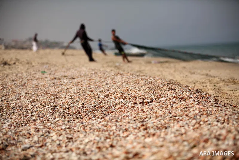Palestinian fishermen throw thier nets into the sea at the beach of Gaza City on April 03, 2016. Israel on Sunday extended the distance it permits Gaza fishermen to head out to sea along certain parts of the coastline of...