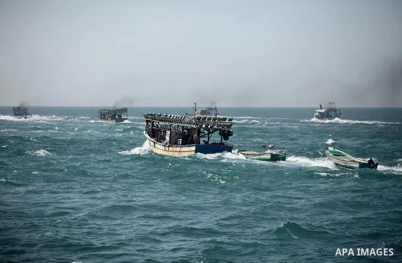 Palestinian fishermen ride their fishing boat at the beach of Gaza City on April 03, 2016. Israel on Sunday extended the distance it permits Gaza fishermen to head out to sea along certain parts of the coastline of the e...