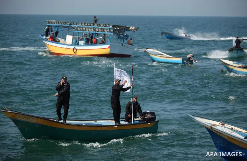 Palestinian fishermen ride their fishing boat at the beach of Gaza City on April 03, 2016. Israel on Sunday extended the distance it permits Gaza fishermen to head out to sea along certain parts of the coastline of the e...