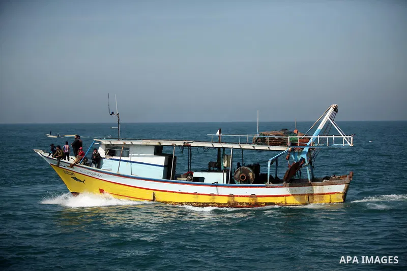 Palestinian fishermen ride their fishing boat at the beach of Gaza City on April 03, 2016. Israel on Sunday extended the distance it permits Gaza fishermen to head out to sea along certain parts of the coastline of the e...