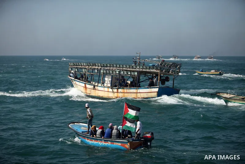 Palestinian fishermen ride their fishing boat at the beach of Gaza City on April 03, 2016. Israel on Sunday extended the distance it permits Gaza fishermen to head out to sea along certain parts of the coastline of the e...