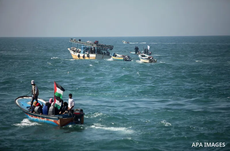 Palestinian fishermen ride their fishing boat at the beach of Gaza City on April 03, 2016. Israel on Sunday extended the distance it permits Gaza fishermen to head out to sea along certain parts of the coastline of the e...