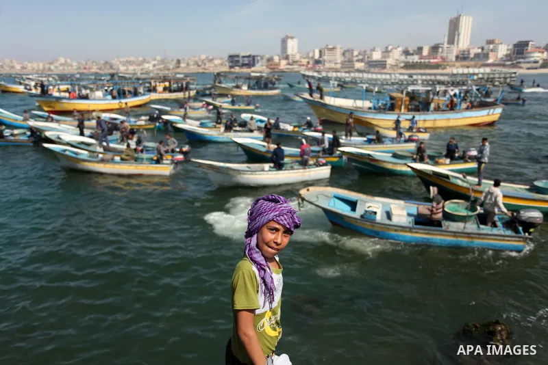 Palestinian fishermen ride their fishing boat at the beach of Gaza City on April 03, 2016. Israel on Sunday extended the distance it permits Gaza fishermen to head out to sea along certain parts of the coastline of the e...