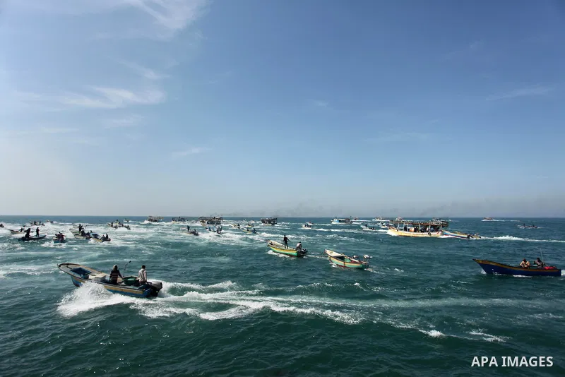 Palestinian fishermen ride their fishing boat at the beach of Gaza City on April 03, 2016. Israel on Sunday extended the distance it permits Gaza fishermen to head out to sea along certain parts of the coastline of the e...