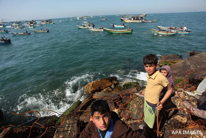 Palestinian fishermen ride their fishing boat at the beach of Gaza City on April 03, 2016. Israel on Sunday extended the distance it permits Gaza fishermen to head out to sea along certain parts of the coastline of the e...