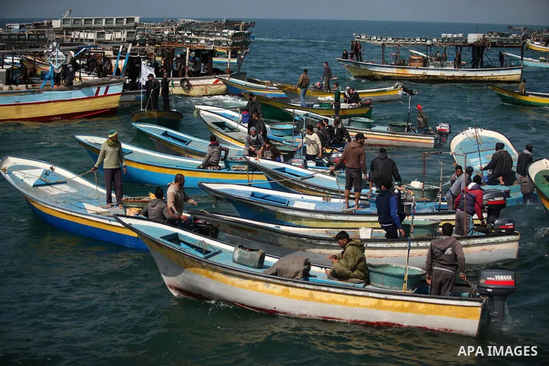 Palestinian fishermen ride their fishing boat at the beach of Gaza City on April 03, 2016. Israel on Sunday extended the distance it permits Gaza fishermen to head out to sea along certain parts of the coastline of the e...